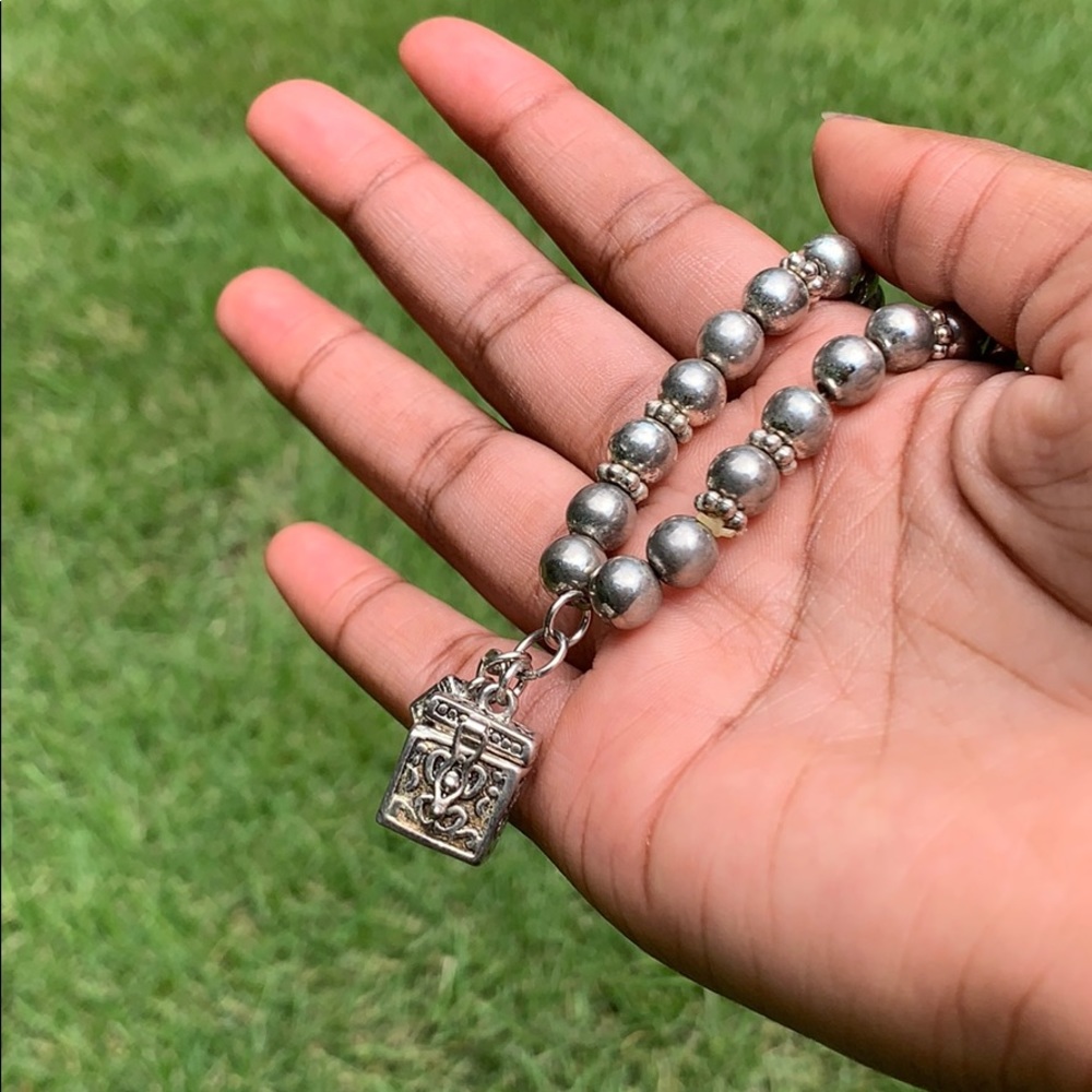 Vintage charm bracelet with small opening box.